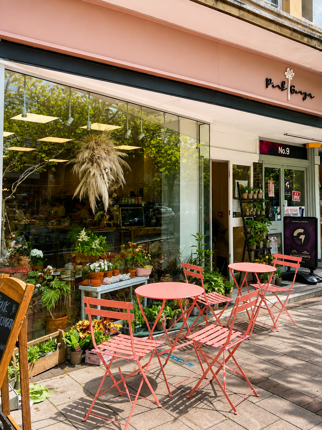 Pink Ginger Flower Cafe storefront with pink outdoor seating