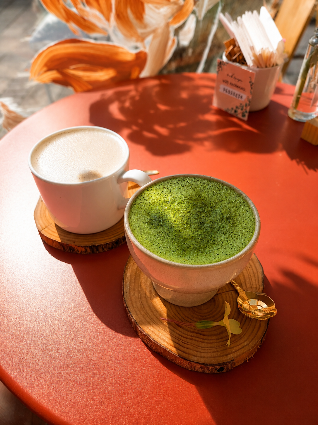 Matcha and a light-coloured drink on wooden trays